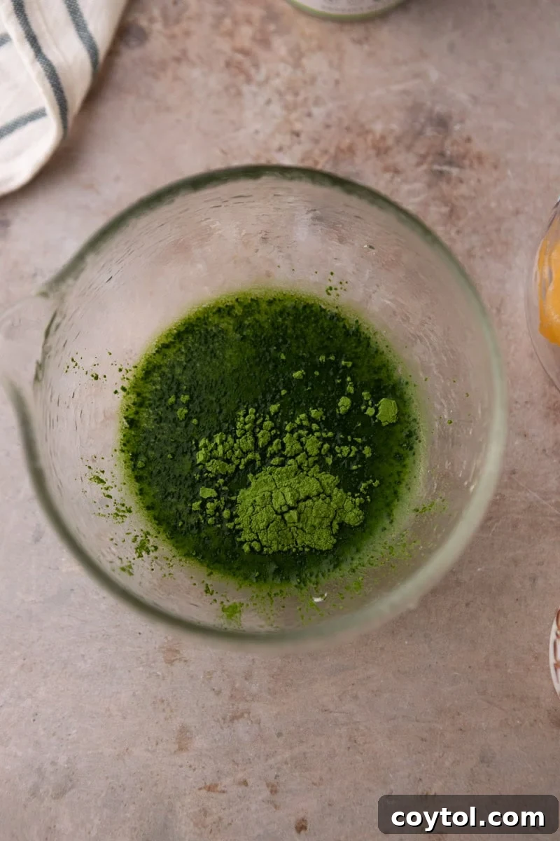 Fresh Mango Matcha Coconut Water Delight 6 matcha powder in a small glass bowl, ready to be whisked with hot water