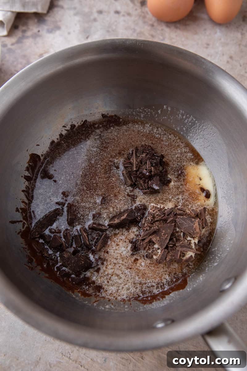 Chopped dark chocolate and butter in a stainless steel saucepan before melting
