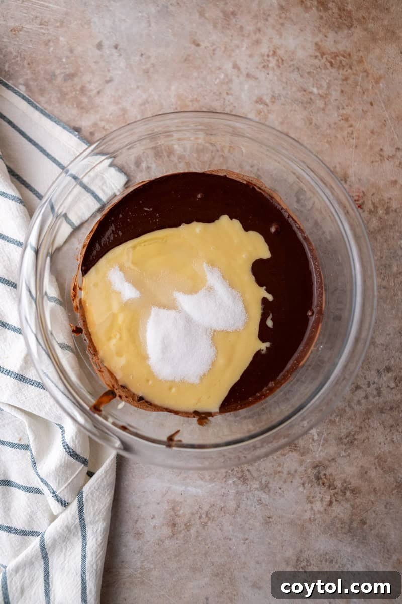 Vanilla cake batter with added sugar and the bloomed cocoa paste being combined to create the distinct chocolate marble batter