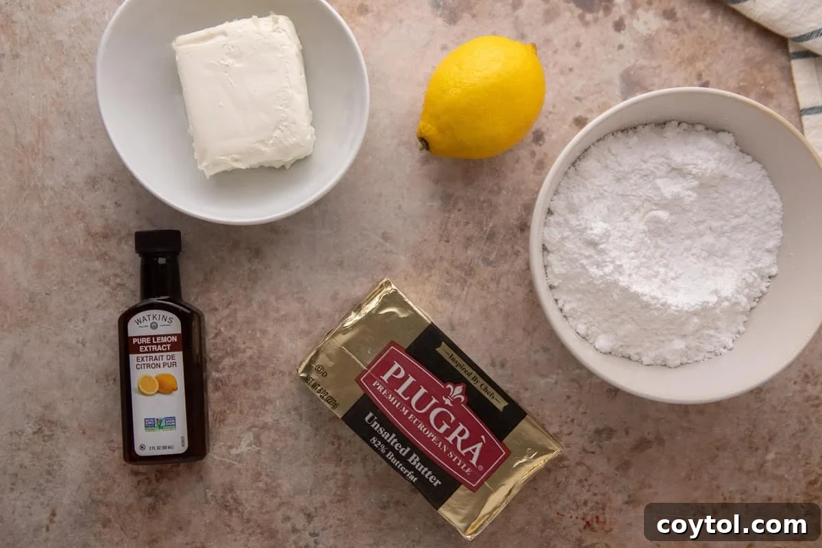 Cream cheese lemon frosting ingredients flatlay with Plugrà butter, cream cheese, powdered sugar, lemon, and lemon extract.