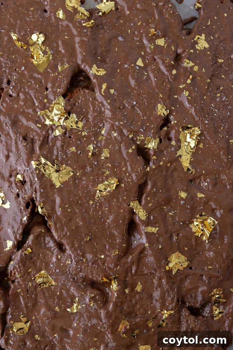 Croissant Christmas crack topped with melted chocolate, flaky salt, and edible gold leaf