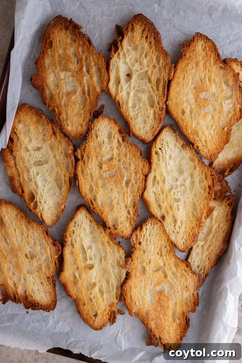 Pressed croissants baked deep golden and crisp on parchment, ready for toffee
