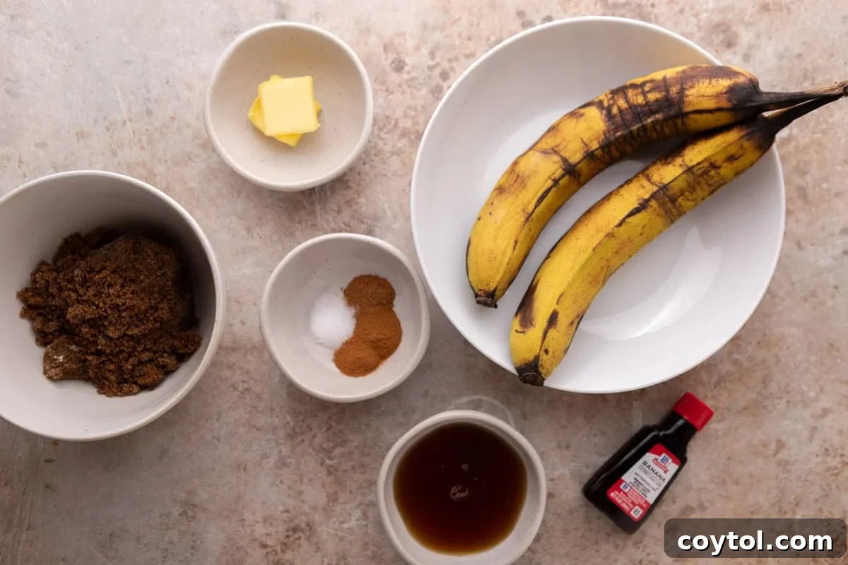 Ingredients for banana bread syrup laid out in white bowls including overripe bananas, butter, dark brown sugar, cinnamon, maple syrup, and banana extract