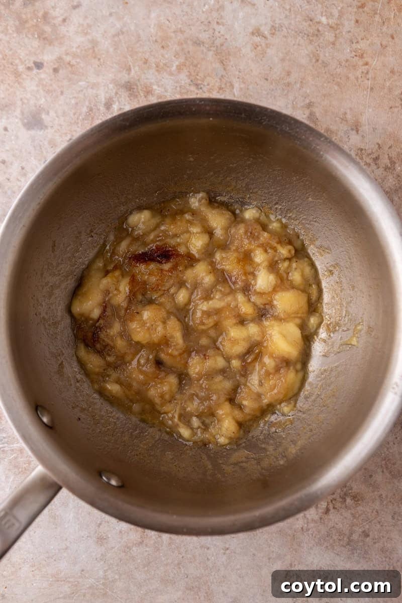 Mashed bananas caramelizing in brown butter in a saucepan