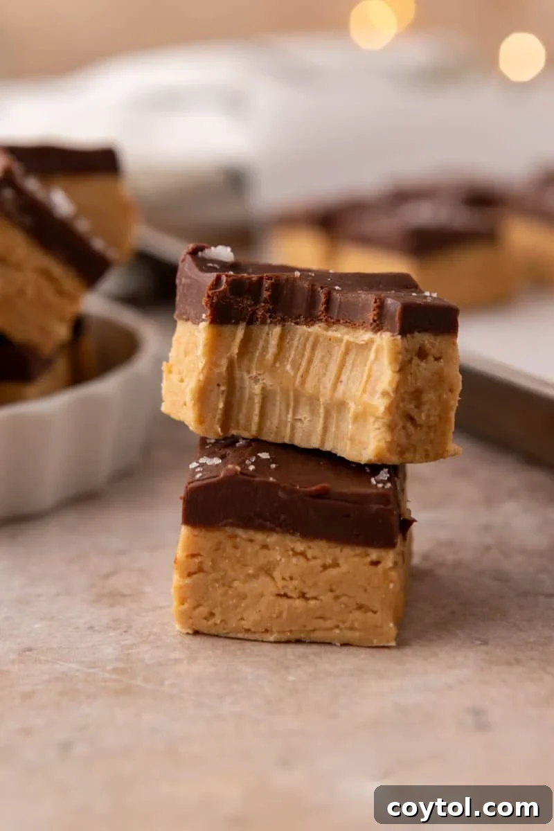 Close up of buckeye fudge showing the peanut butter layer and chocolate top with a bite taken