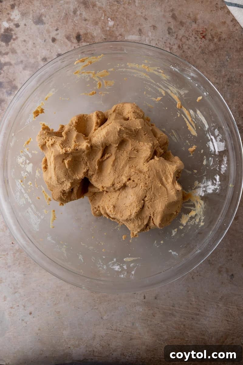 Thick peanut butter fudge dough formed into a ball in a glass bowl
