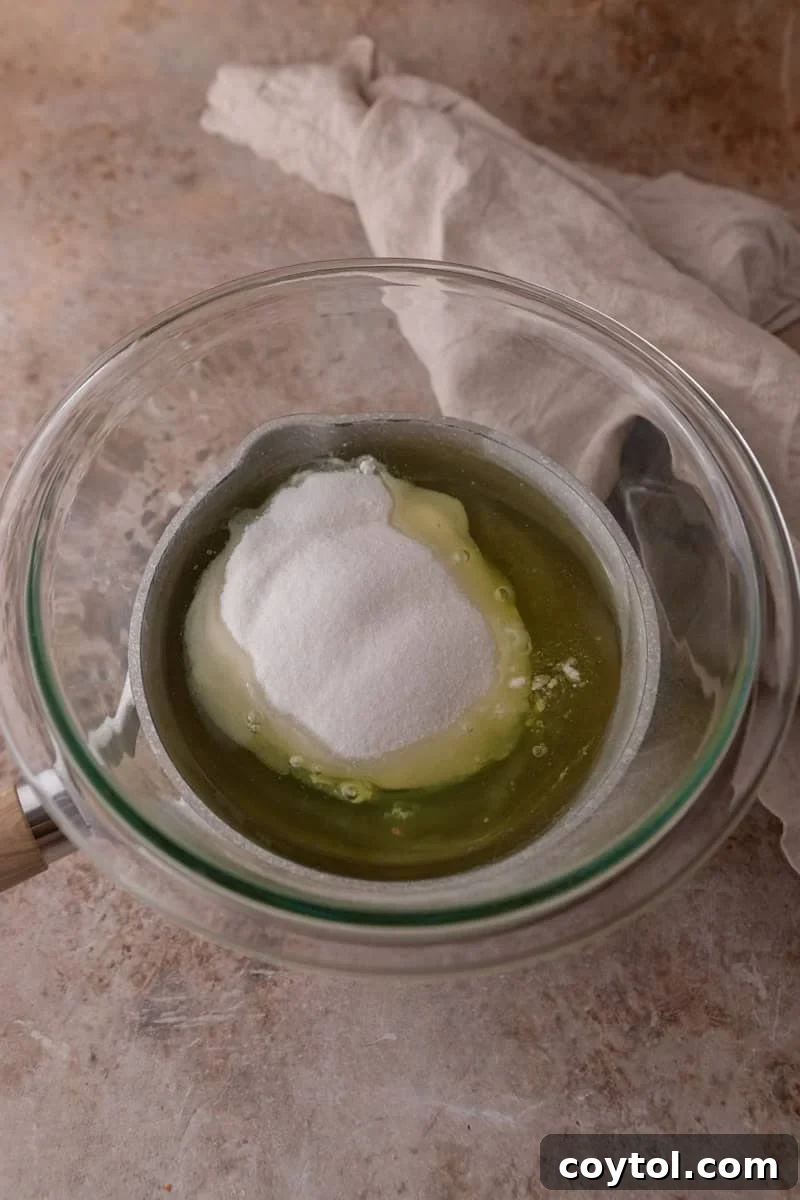 Egg whites and sugar in a glass bowl to make Swiss meringue
