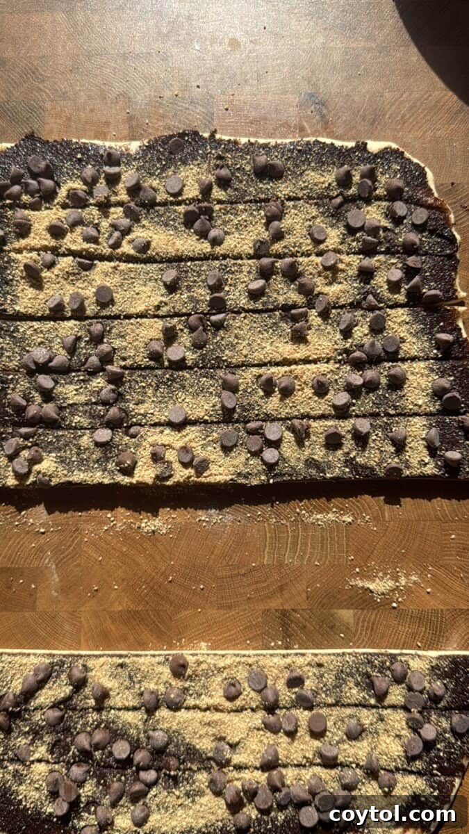  Chocolate and graham covered dough cut into strips for rolling into cinnamon rolls