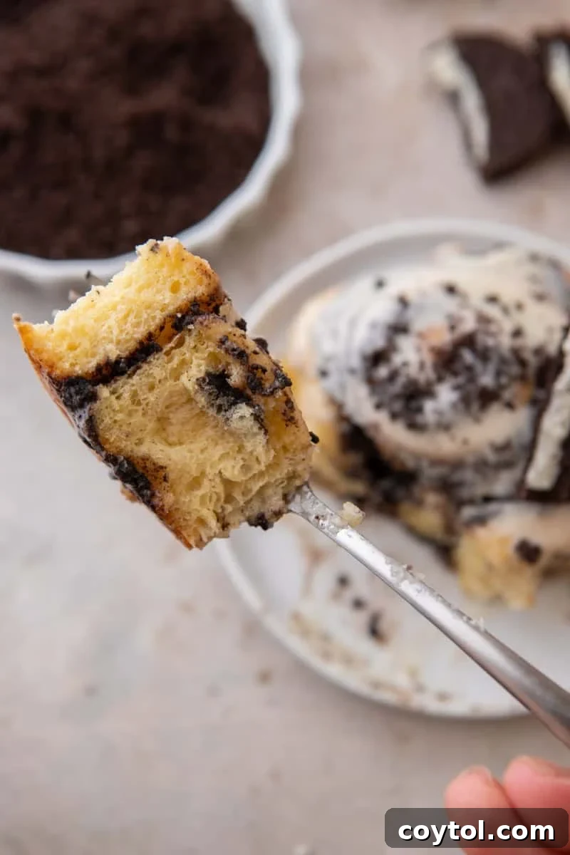 Forkful of Oreo cinnamon roll showing the soft interior and Oreo filling swirl