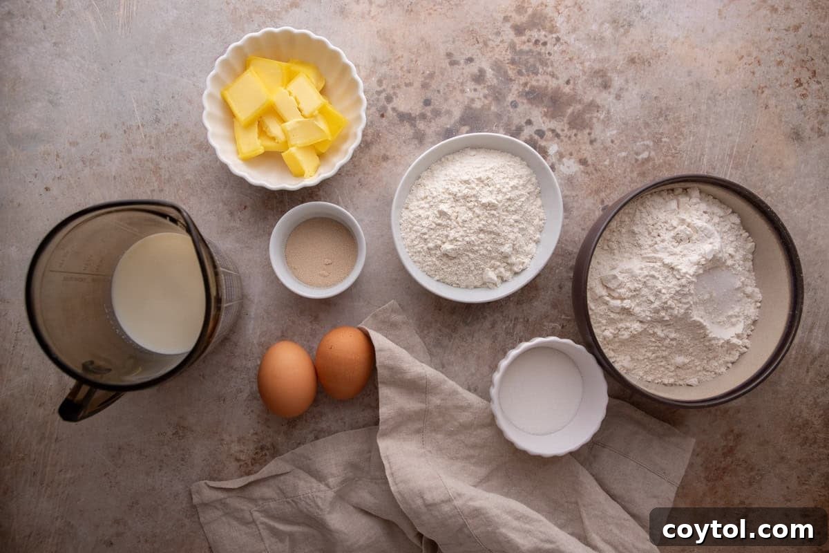 Ingredients for brioche cinnamon roll dough including flour, butter, eggs, and yeast