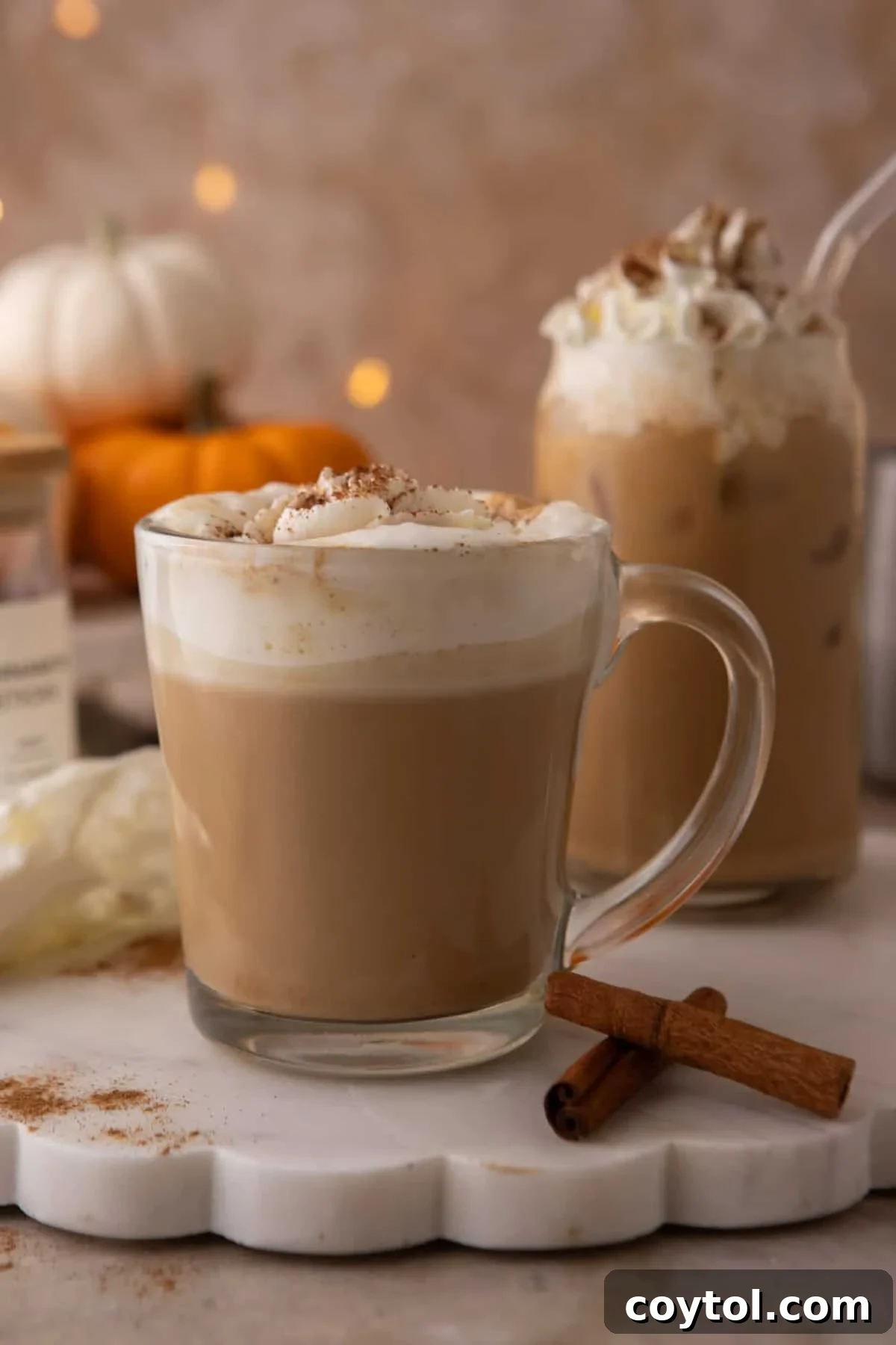 Copycat Starbucks pumpkin spice latte in a glass mug with whipped cream and spice dusting.